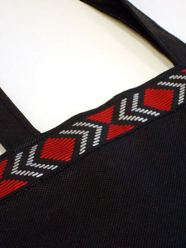 Eco bag hold all out of polypropylene trimmed with Maori design braid